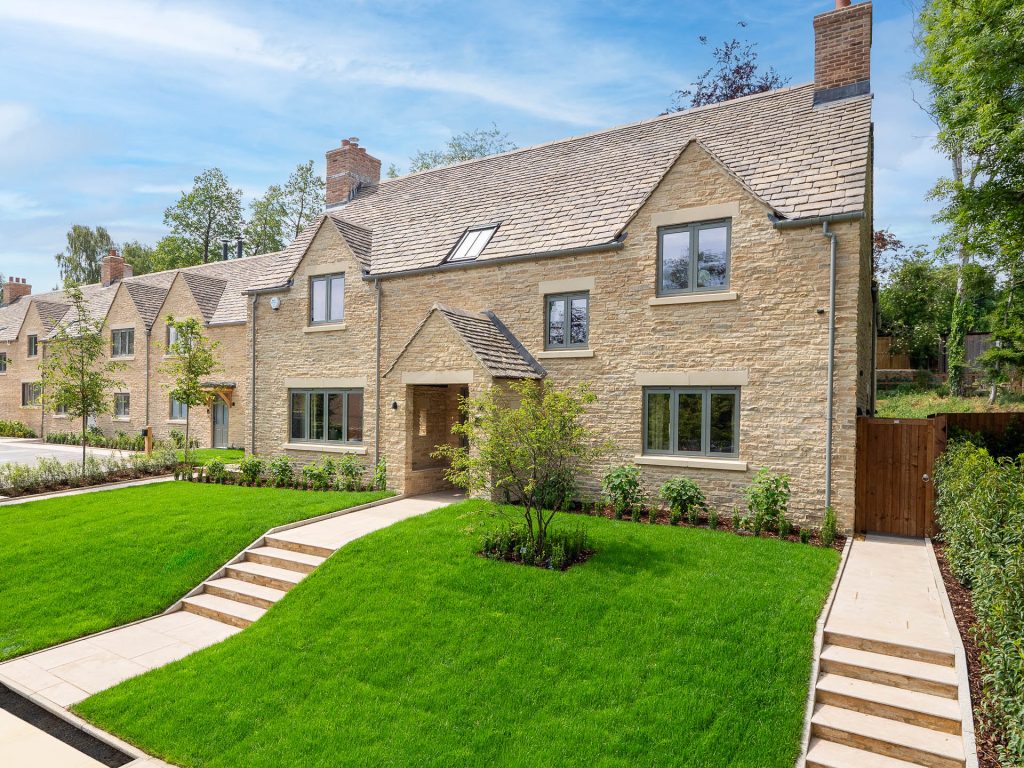 Multiple homes with canopy entrances and grey doors and windows