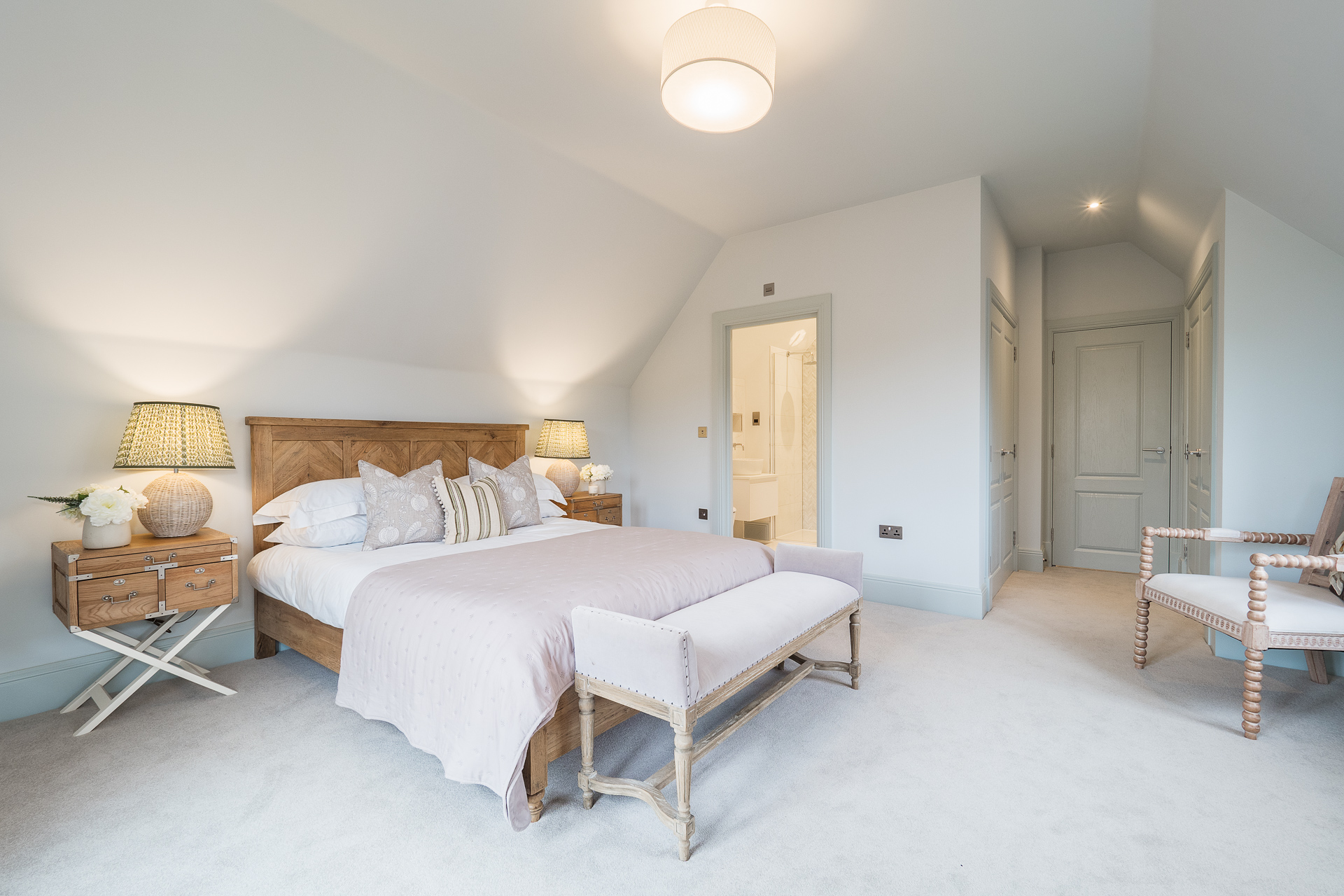 Bedroom with two built in wardrobes, wooden bed and ensuite