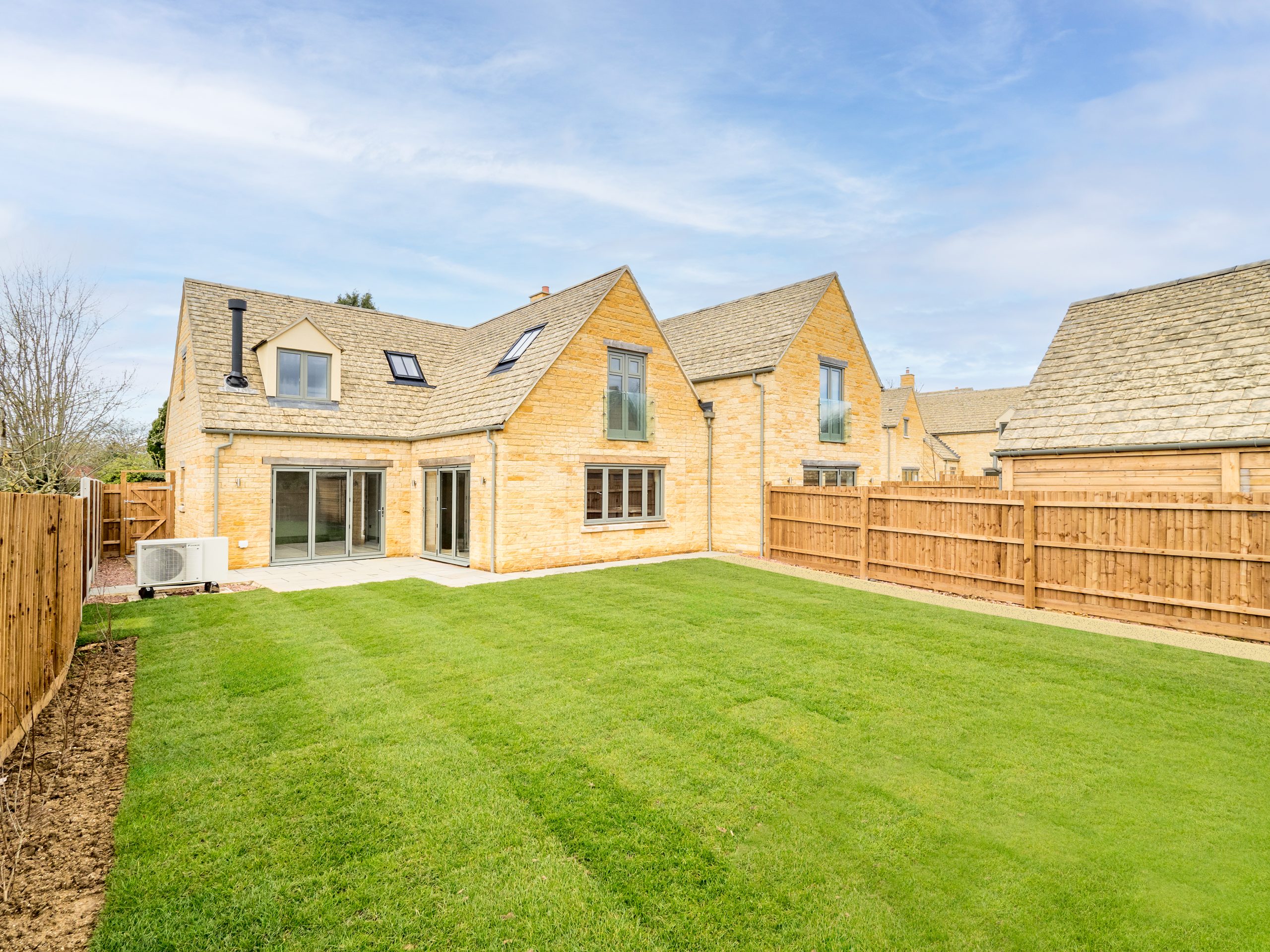 House with large grass garden and two sets of patio doors