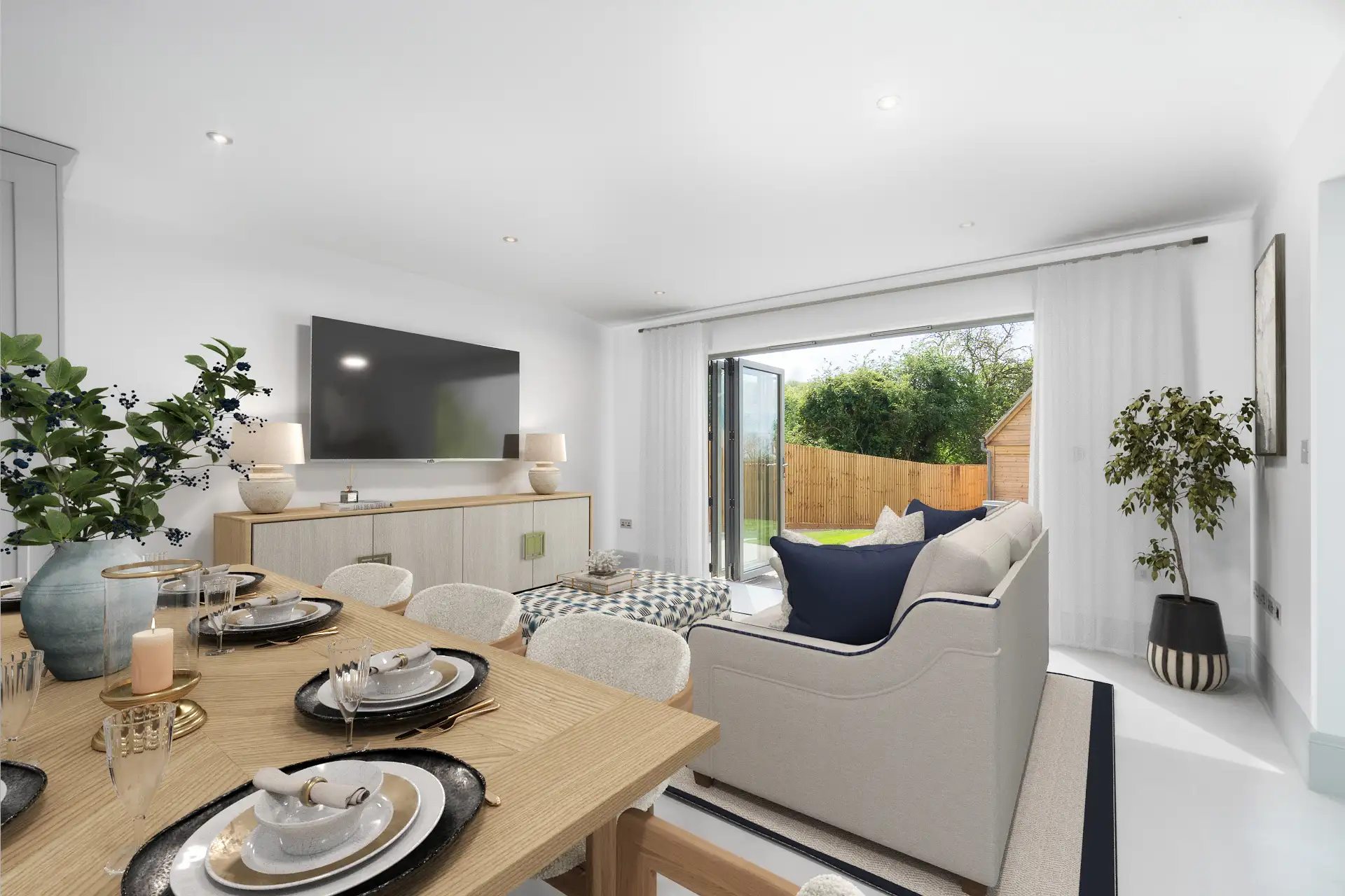 Living and dining room with dark grey patio doors leading to garden and oak table
