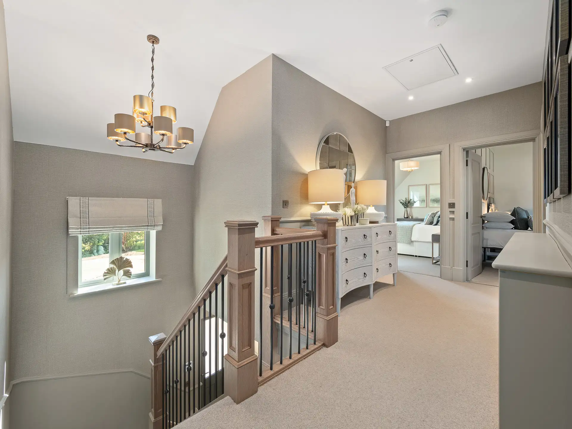 Upstairs landing with light grey doors to bedroom and ashy banisters