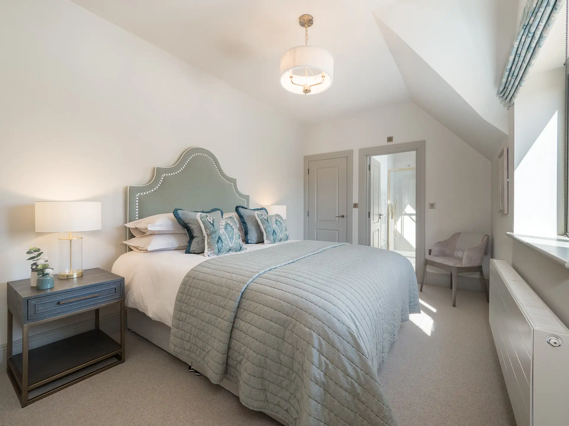 Double bedroom with light grey doors and ensuite