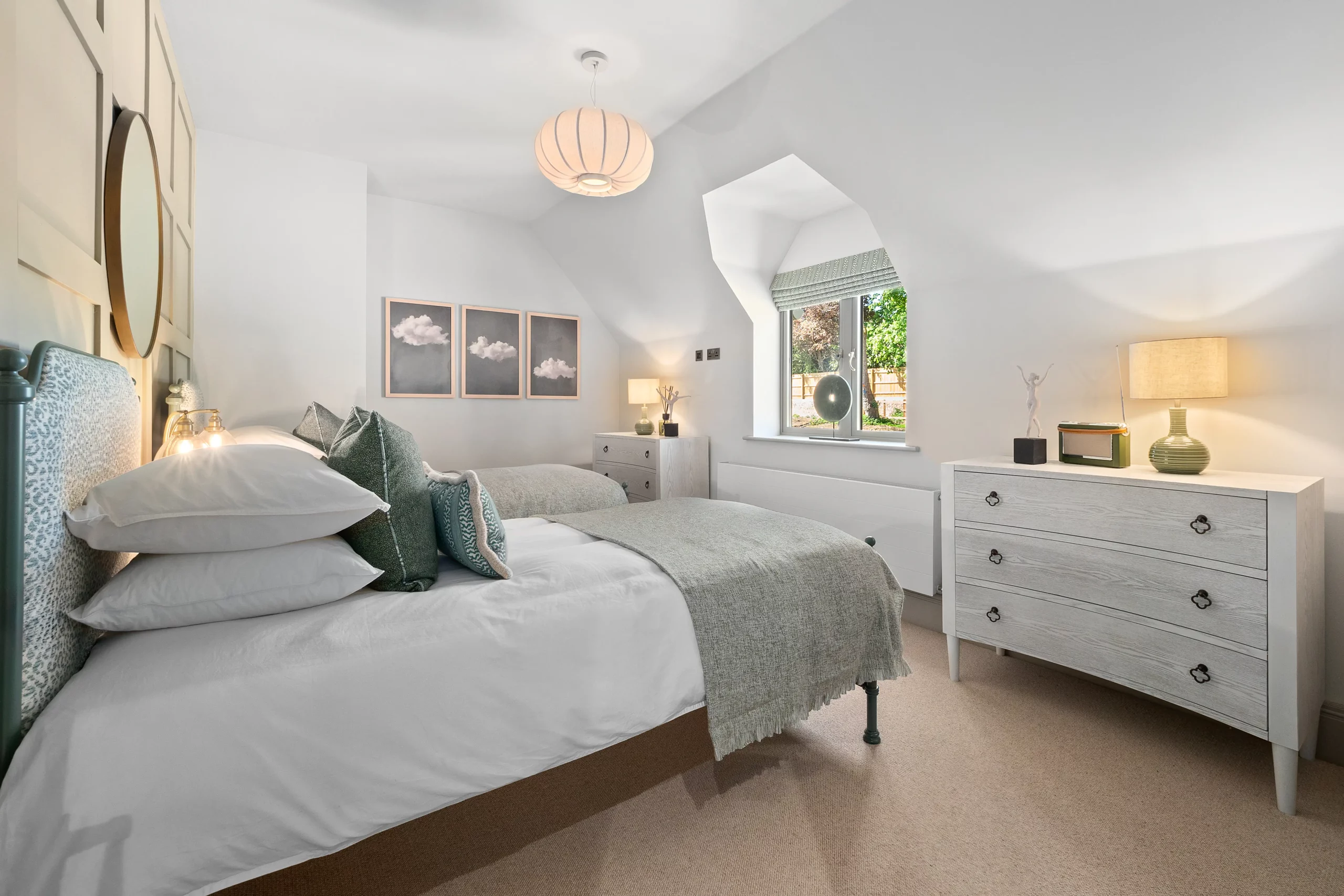 Bedroom with panelled accent wall to the ceiling and white ashy chest of drawers