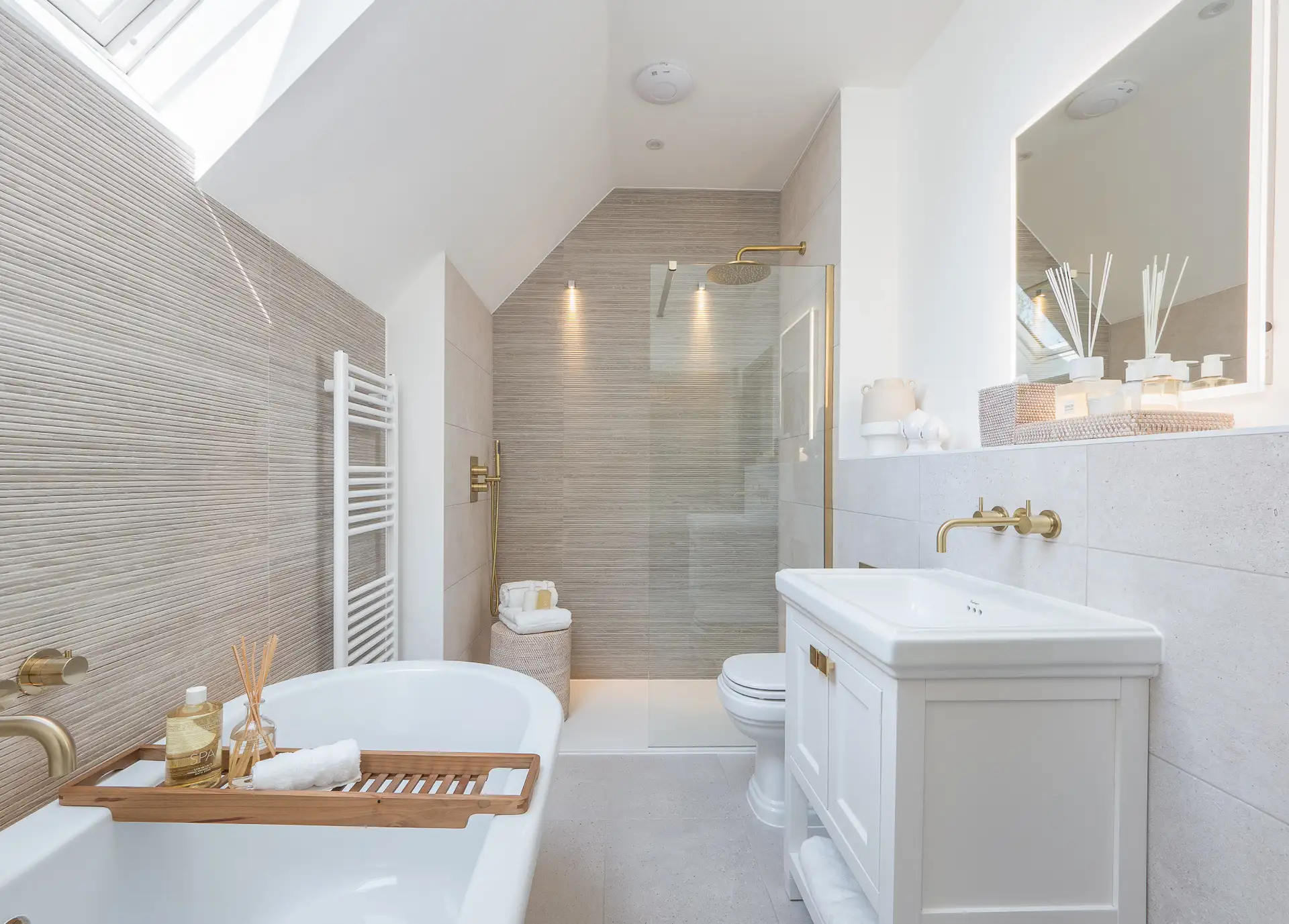 bathroom with gold hardware and beige accent walls