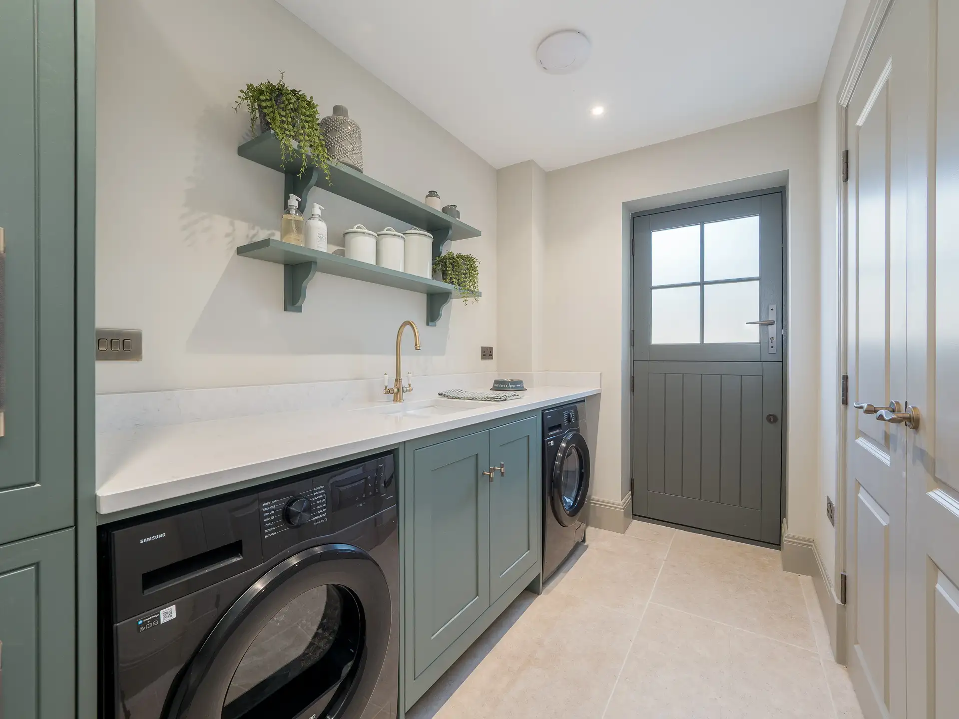 Dark, forest green utility with stable door and gold hardware