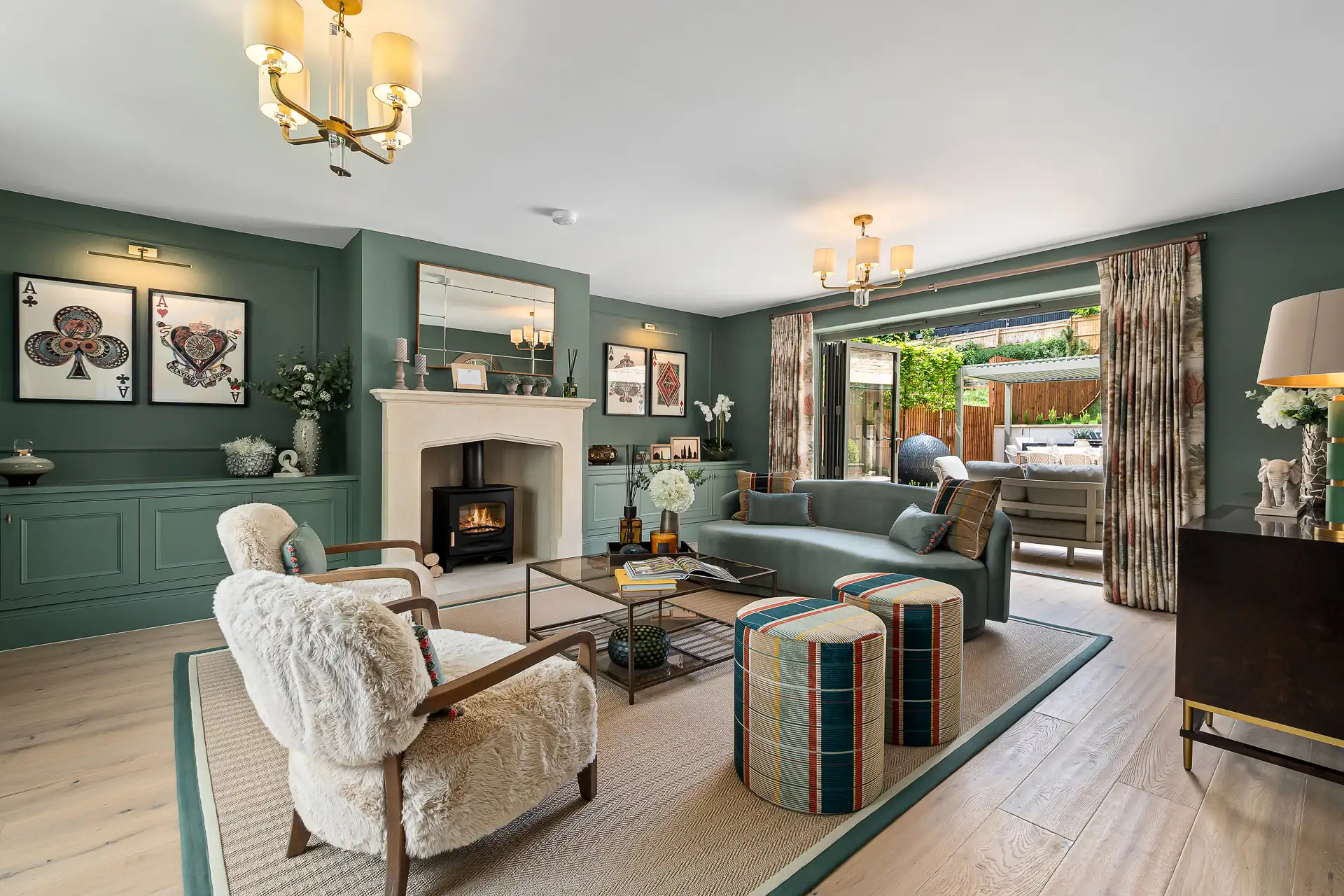 Green living room with wooden floor and patio doors to the garden