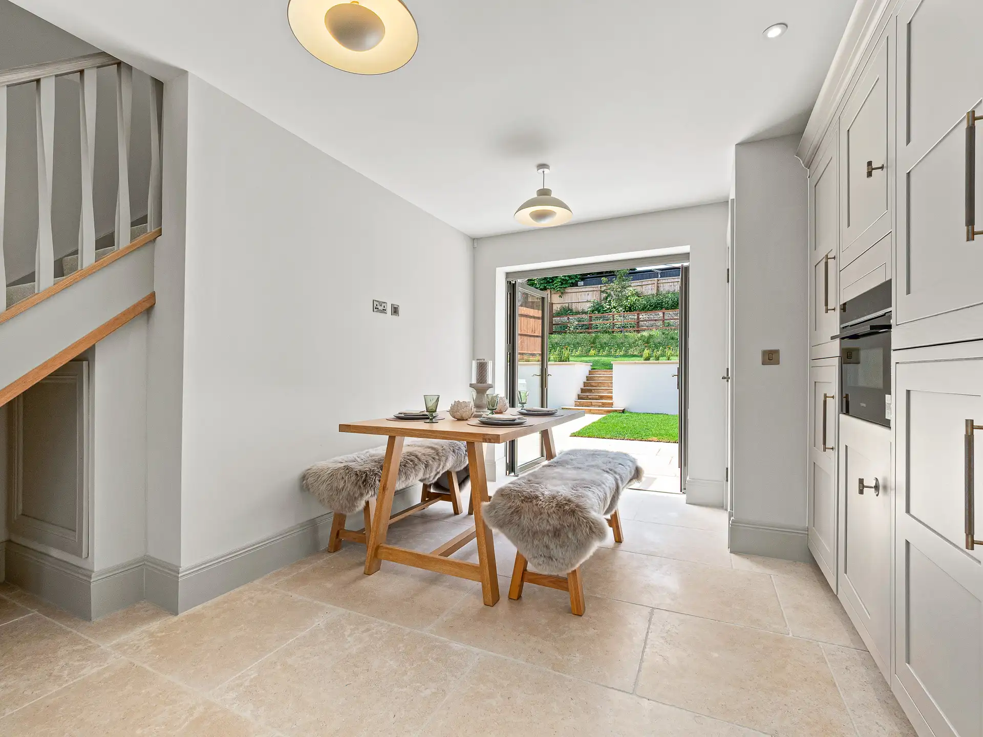 Kitchen cupboards with wooden tables with benches