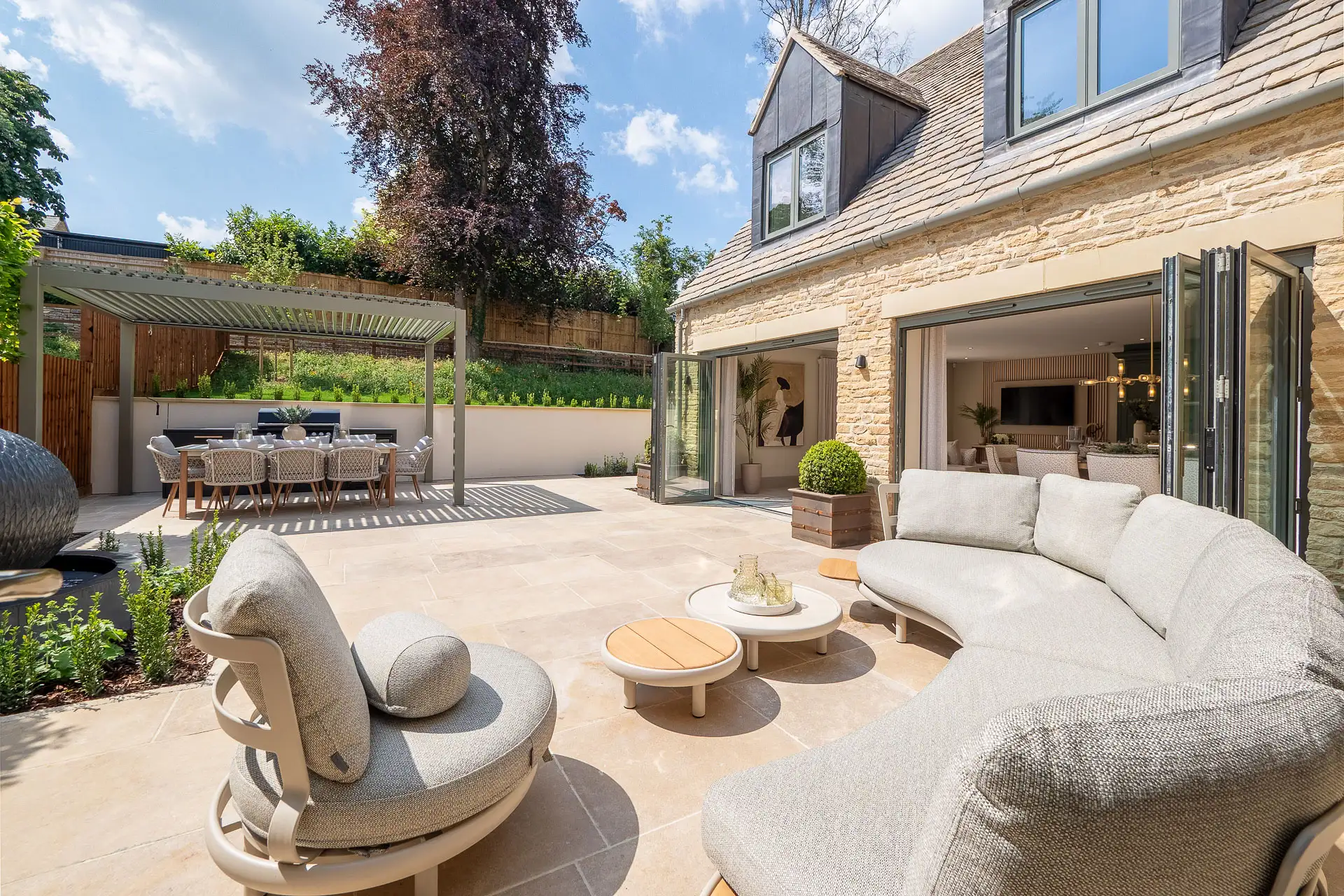 Patio garden with large, curved out door sofa and two sets of patio doors