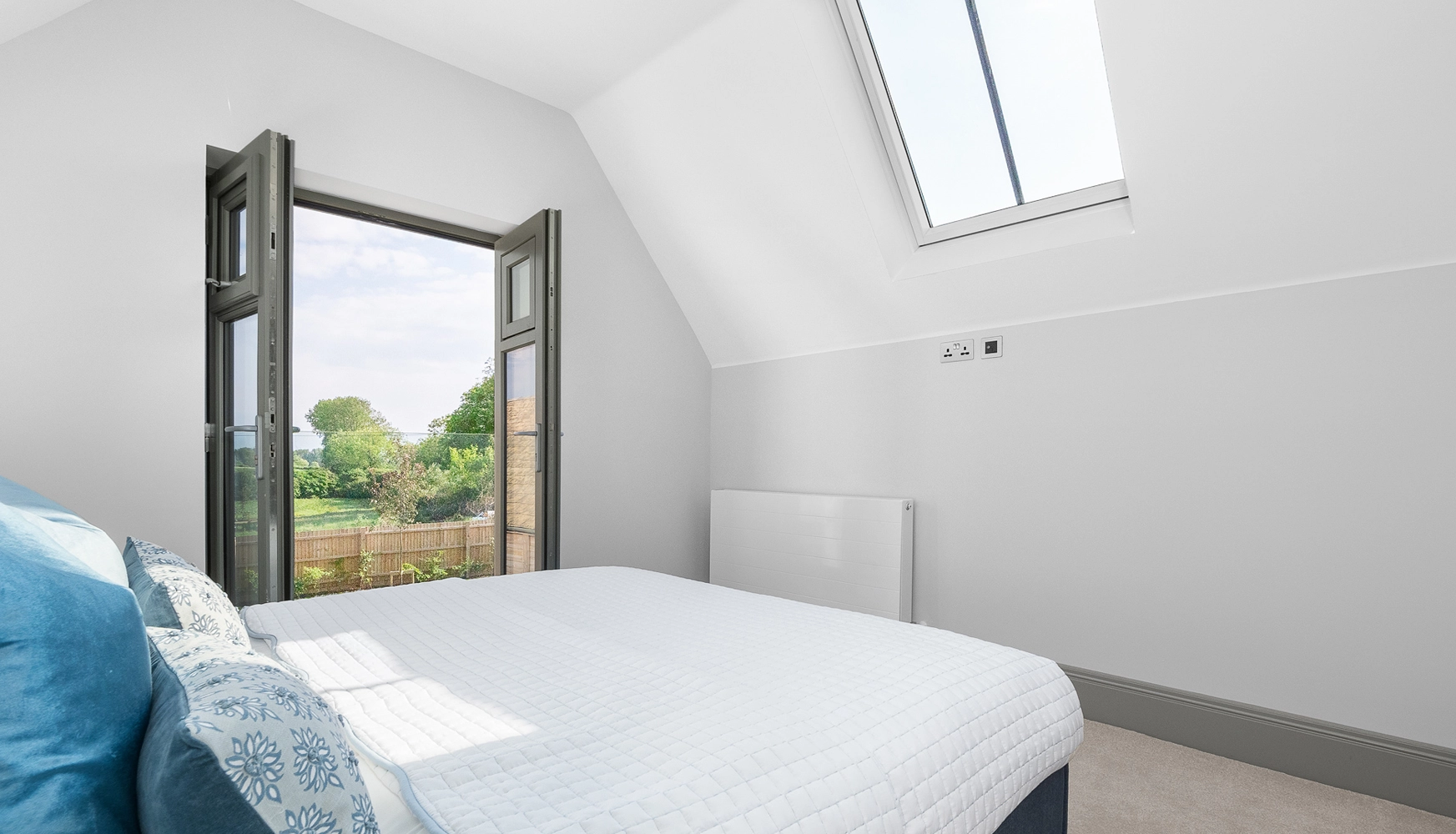 Bedroom with skylight and grey skirting boards