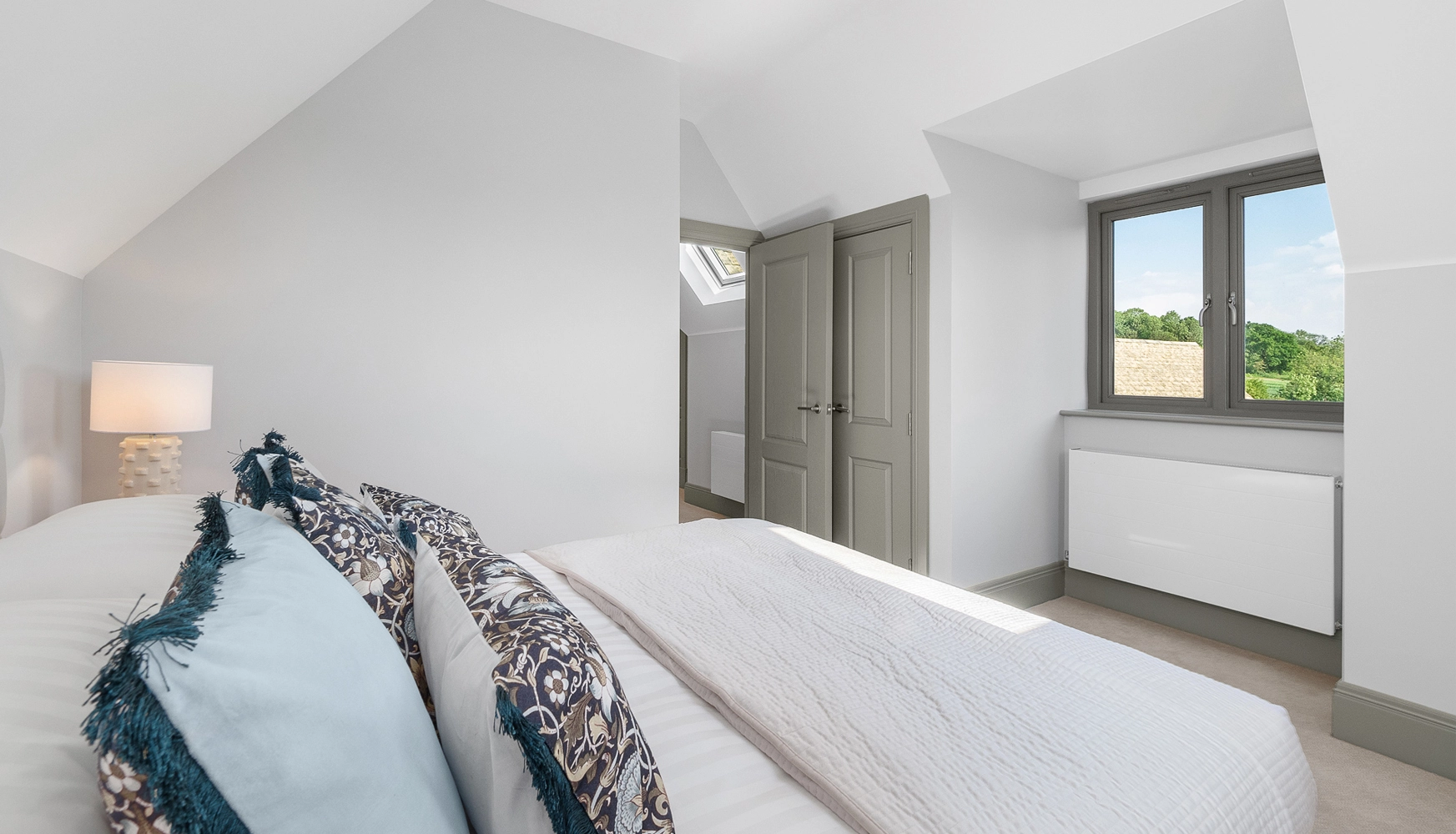 Bedroom with built in wardrobe and window opposite bed