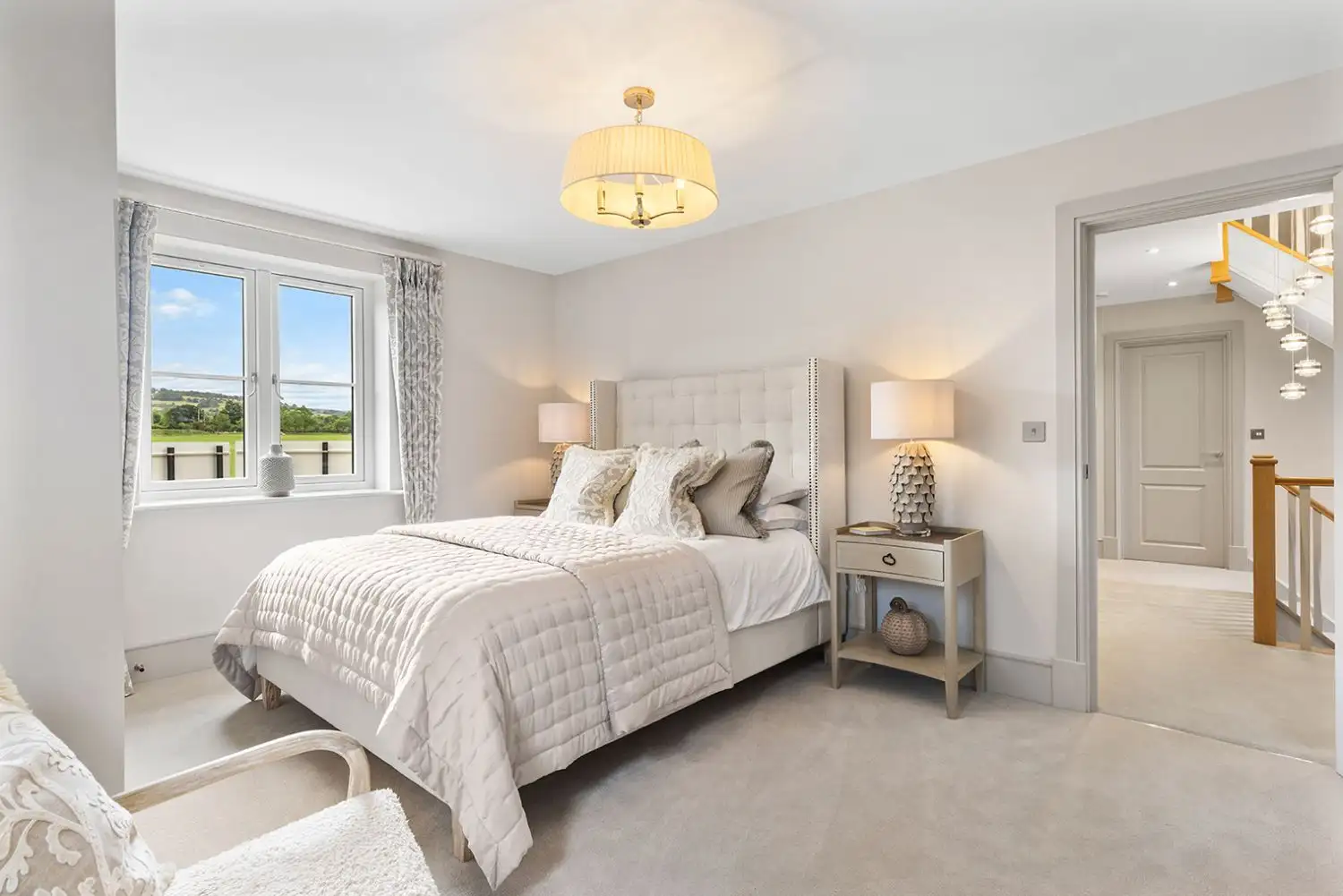 Bedroom with double window and beige bed
