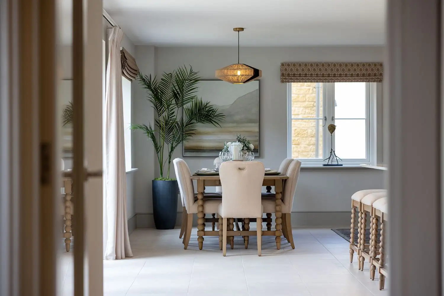 Photo of dining table in open plan kitchen with light tiled floor