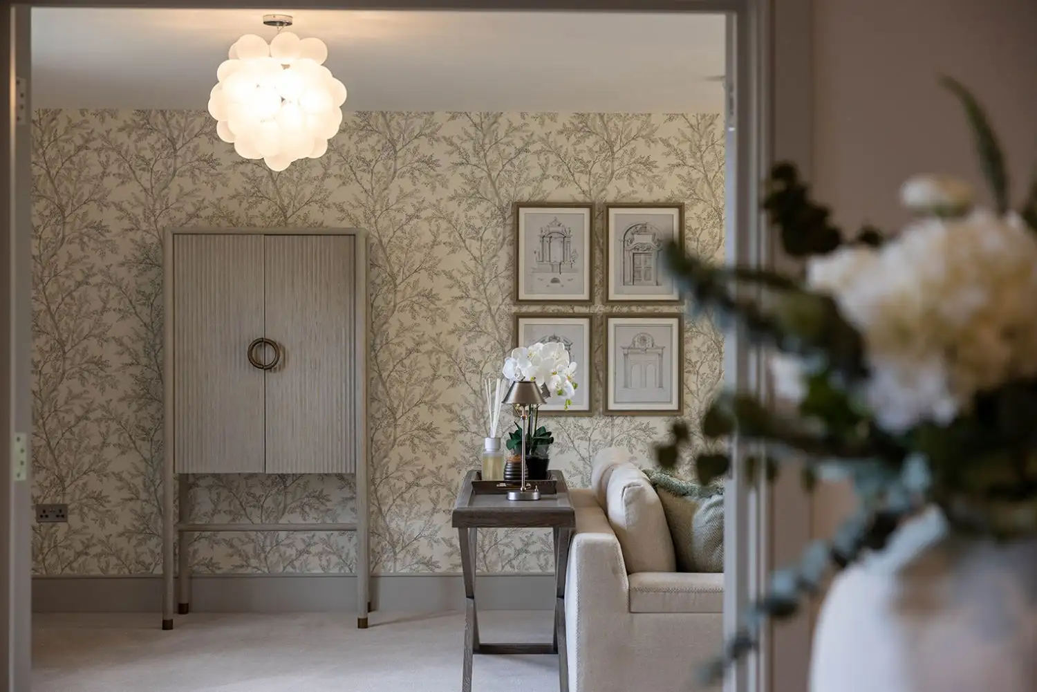 Living room with decorative wallpaper and beige carpet