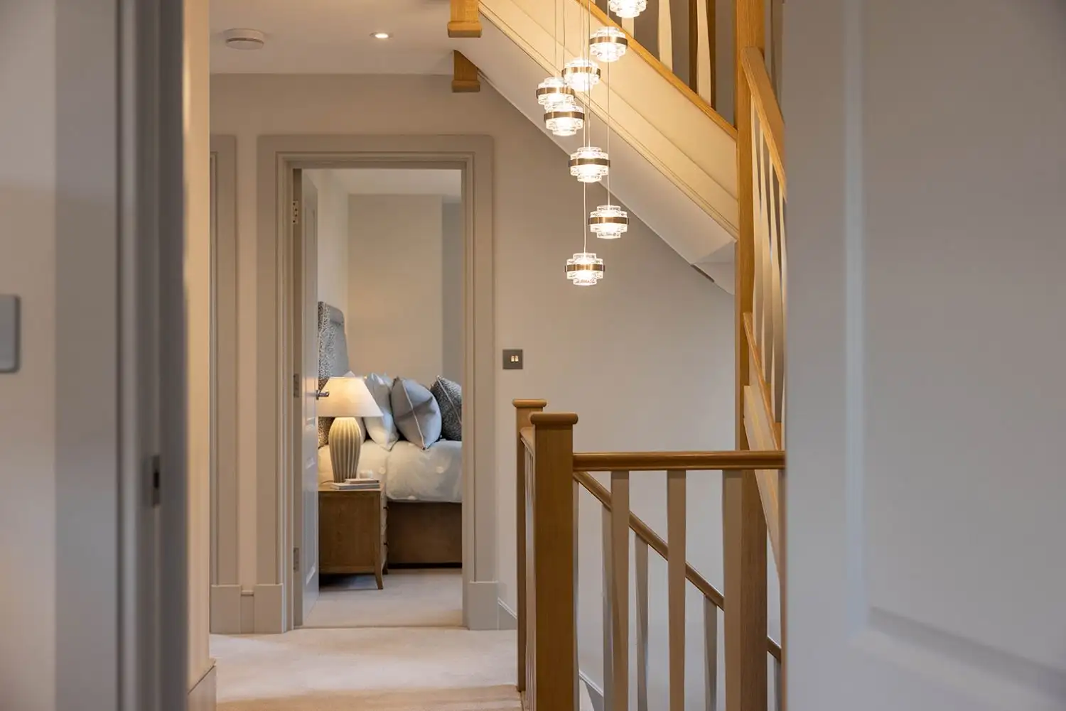 Hallway photo showing three floor stairs in an oak wooden colour